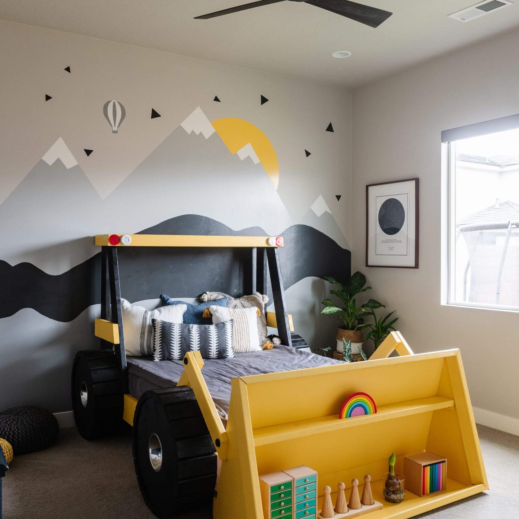 Etch Design Group in Austin, Texas - custom home designed to be comfortable and polished to make a bold statement - boy's bedroom with construction themed bed and mountain accent wall.