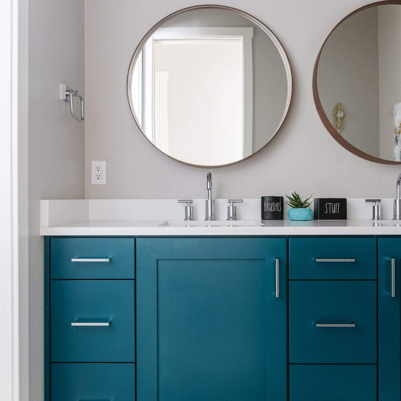 Etch Design Group in Austin, Texas - custom home designed to be comfortable and polished to make a bold statement - boy's bedroom with construction themed bed and mountain accent wall - bathroom with double sinks and double mirrors.